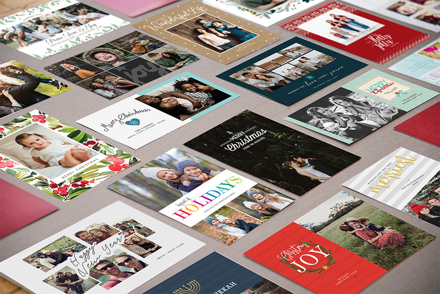 group of holiday cards laying on table